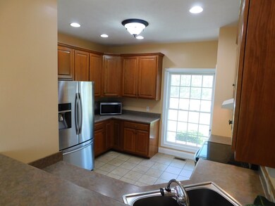 Beautiful window to bring the daylight  inside the kitchen. This kitchen offers a dishwasher, coffee bar, serving bar, and pantry.  Refrigerator stays with property.