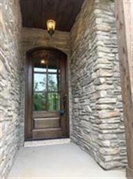 Stone, upgraded door and trimmed wood ceiling on f