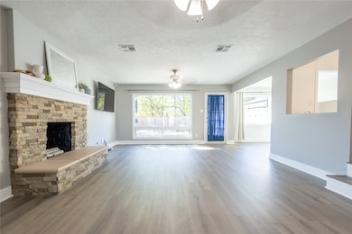 Open living area with woodburning fireplace and gorgeous picture window!