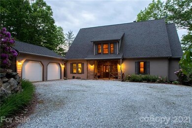 Driveway view of house and detached 2 car garage.