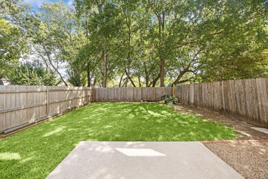 Fenced backyard with view of scattered trees