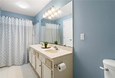 The upstairs full bathroom that services both bedr