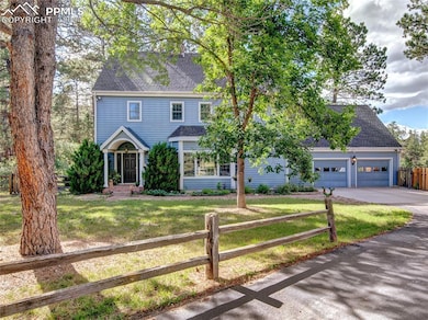 Colonial inspired home featuring a garage and a fr