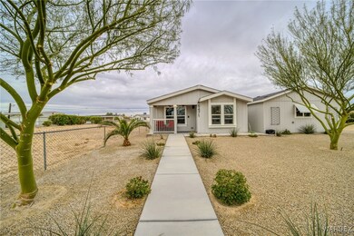 View of front of house featuring a porch and fence