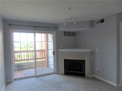 Living room with gas fireplace and patio door to d