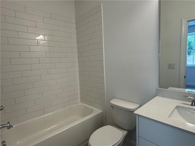 Half bathroom featuring toilet, wood finished floo