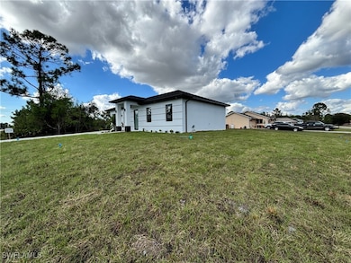 View of side of home featuring a lawn