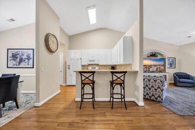 Kitchen with a peninsula, white appliances, light 