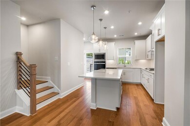 Kitchen with appliances with stainless steel finishes, light wood-style floors, white cabinetry, and recessed lighting