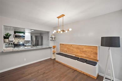 Kitchen featuring sink, white cabinetry, light sto