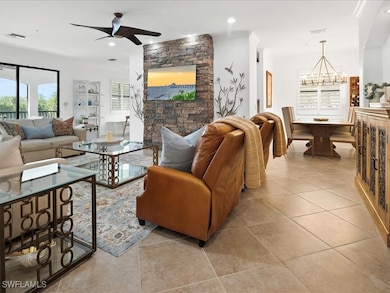 Living area featuring light tile patterned floors, a chandelier, recessed lighting, and ceiling fan