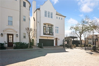 View of front of home with a gate and stucco sidin