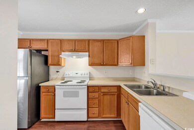 Kitchen with ornamental molding, sink, white appli