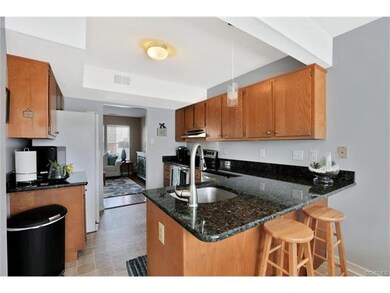 Handsome kitchen with granite counter tops.  Addit