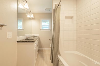 Bathroom with vanity and shower / bathtub combination with curtain