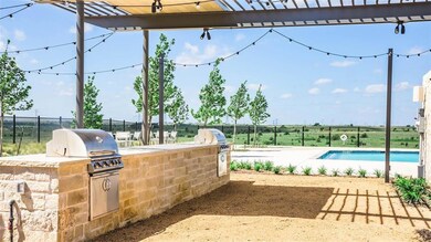 View of patio with a community pool, a grill, and 