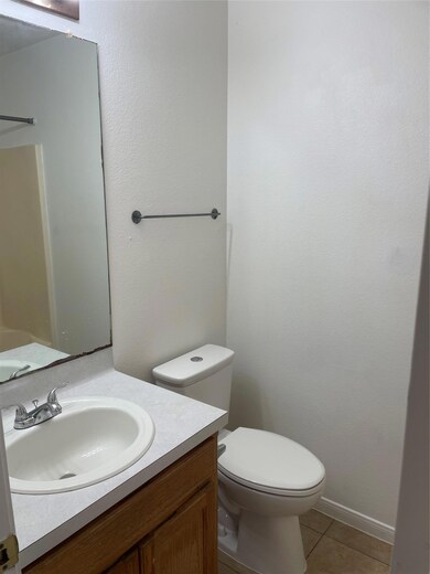 Bathroom with vanity, tile patterned floors, toil