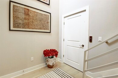 Entrance foyer with wood finished floors, baseboa
