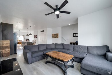 Living area featuring recessed lighting, light wood finished floors, and ceiling fan