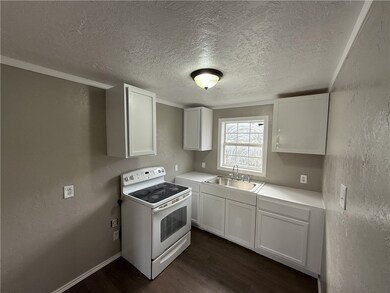 Kitchen with dark wood finished floors, light coun