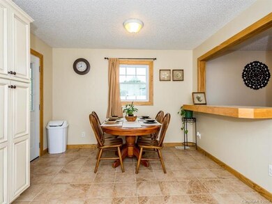 Dining area off kitchen opens up to living room.