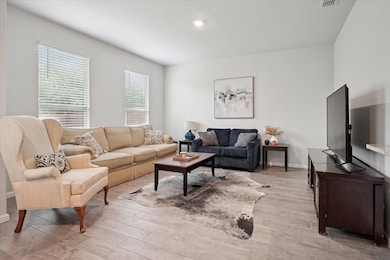 Spacious Living Room with an abundance of natural light and light wood-type flooring and recessed lighting.