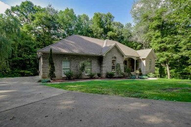 Two car garage on the left side of this beautiful all brick home on 4 private acres!
