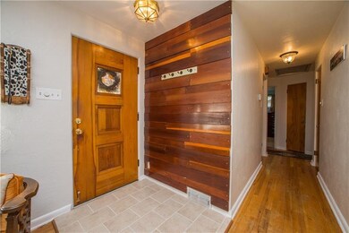 Entry area has been freshly tiled and leads into t