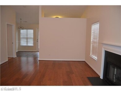 Living Room. Living room with laminate flooring leading to dining room & kitchen. Vaulted ceilings.