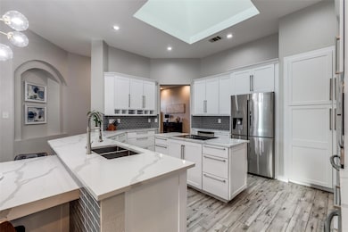 Kitchen with a peninsula, stainless steel fridge 