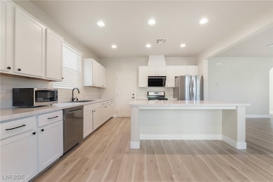 Kitchen featuring stainless steel appliances, a si