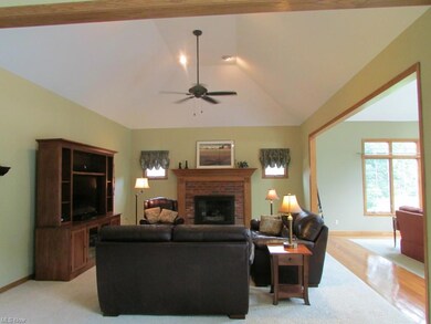 The family room with vaulted ceiling & gas fireplace is open to the kitchen and the morning room/sunroom.