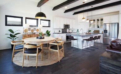Dining space featuring baseboards, beamed ceiling