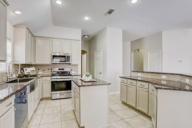 Another view of the kitchen with island and breakfast bar.