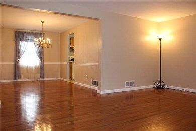 Open floor plan with gleaming hardwood floors.