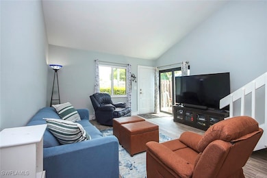 Living room featuring high vaulted ceiling