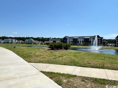 View of property's community featuring a lawn and a  lake/water view