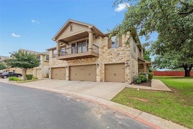 View of property featuring stone siding, a balcon