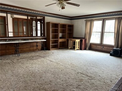 Miscellaneous room with crown molding, light carpe
