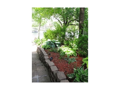 Sidewalk going down to lake. Adjoining flower gard