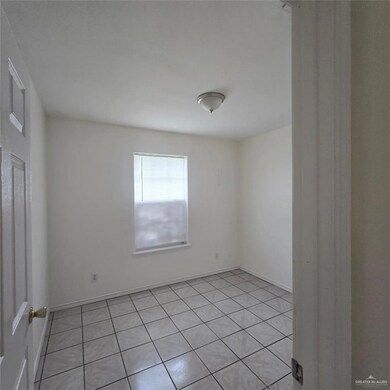 Empty room with light tile patterned flooring
