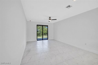 Empty room featuring visible vents, baseboards, a
