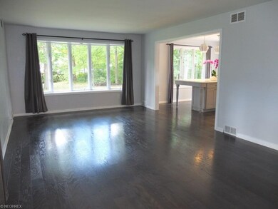 Large family room has a bay window and is open to 