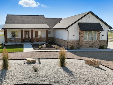 View of front facade with stone siding, a porch, board and batten siding, and a mountain view