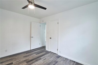 Unfurnished room featuring dark hardwood flooring 