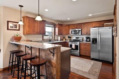 Kitchen with granite counter tops, gas stove and s