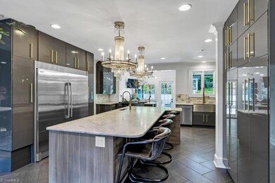 Wow! Huge island all leather counter tops.  Gorgeous lighting and cabinetry.