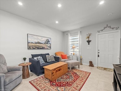 Living area with recessed lighting and light tile patterned floors