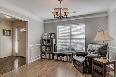 Good sized dining room (currently being used as a living room) with crown moulding, frame moulding, chair rail, big windows, with beautiful vinyl plank flooring.