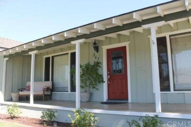 Relax on your covered front porch on this tree cov